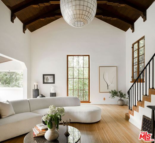 a living room with furniture fireplace and a large window