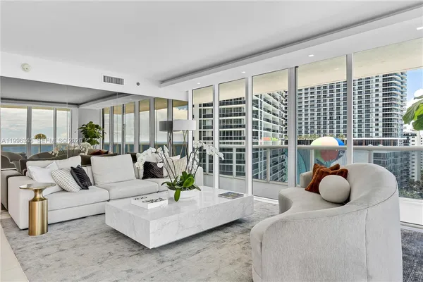 a living room with furniture and a large window