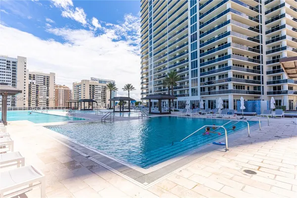 a view of a swimming pool and a lounge chair