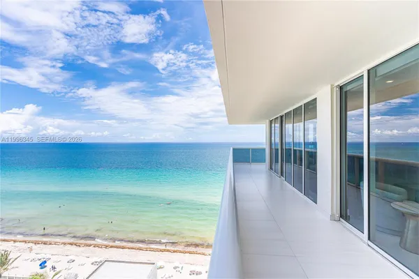 a view of a swimming pool with lawn chairs and a yard