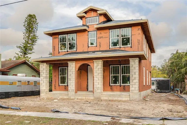 a view of a house with backyard and sitting area