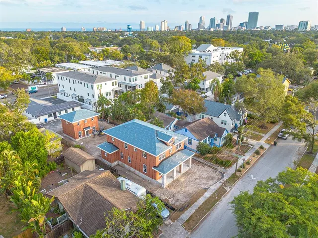 an aerial view of residential houses with outdoor space