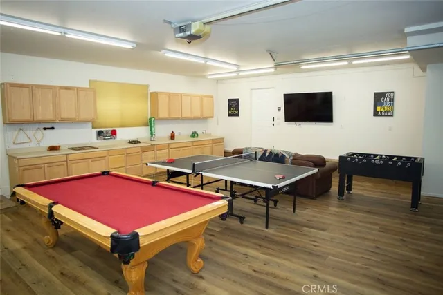 a room with furniture pool table and windows
