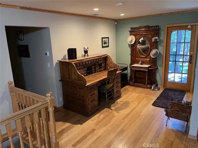 a bedroom with furniture and wooden floor
