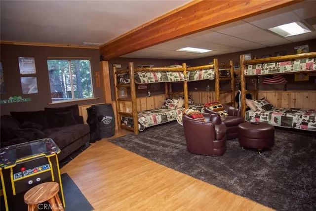 a spacious bedroom with a bed a mirror and a flat screen tv