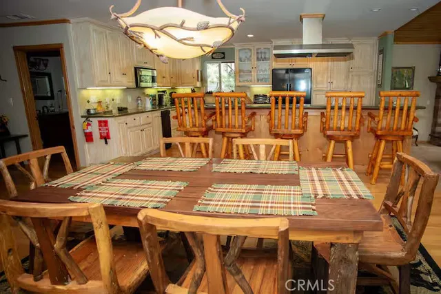 a open kitchen with stainless steel appliances dining table and chairs