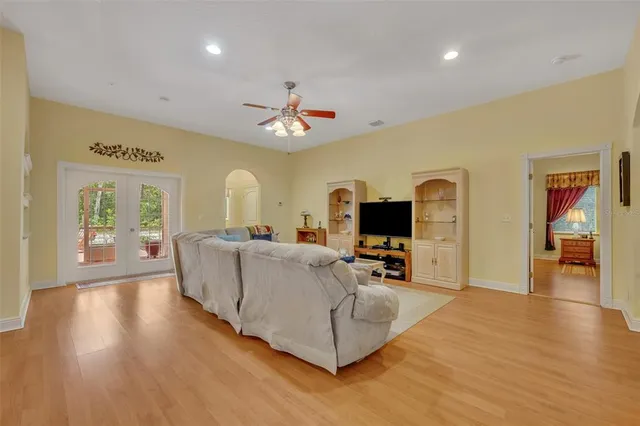 a living room with furniture and a wooden floor