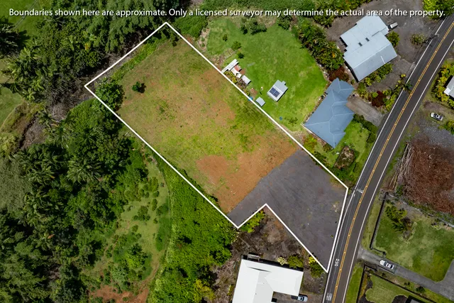an aerial view of a house with yard
