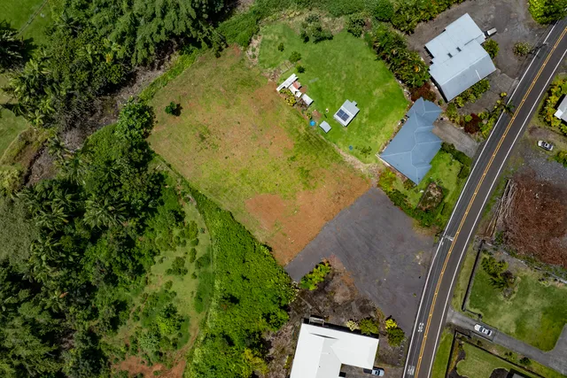 an aerial view of a house with pool yard
