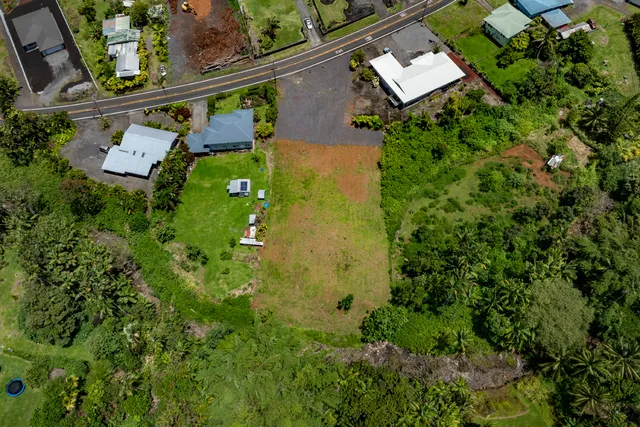 an aerial view of a house with a yard basket ball court and outdoor seating
