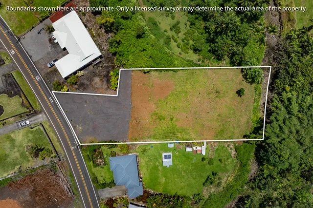 an aerial view of a residential houses with outdoor space and street view