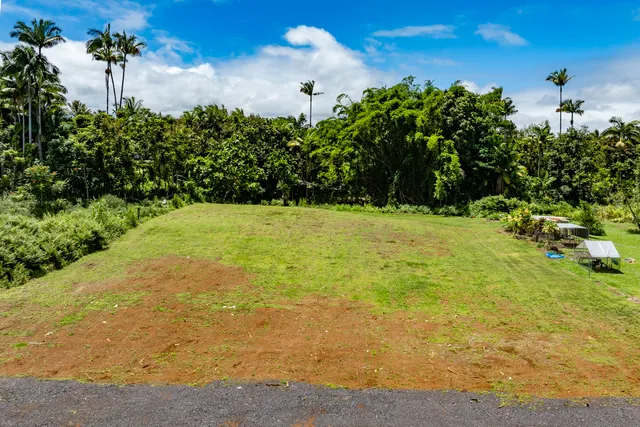 a view of a house with a yard and sitting area
