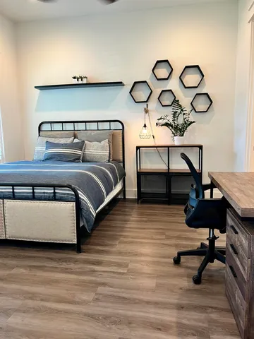 a bedroom with furniture and wooden floor