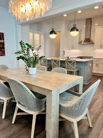 a dining room with furniture and wooden floor