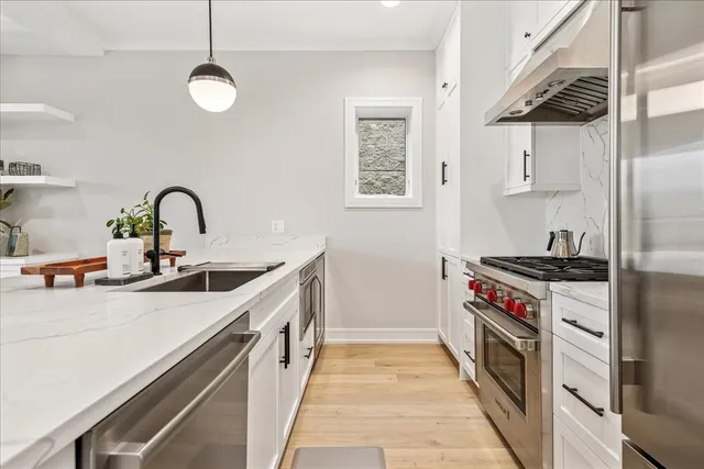 a kitchen with a sink stove and cabinets
