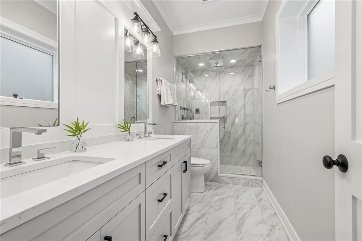 1922 West Belmont Avenue, Unit 3 Chicago, IL 60657 - Photo 20 of 29 a bathroom with a double vanity sink mirror and toilet