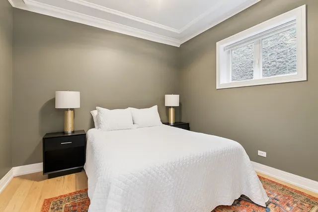 a bedroom with a bed and a lamp