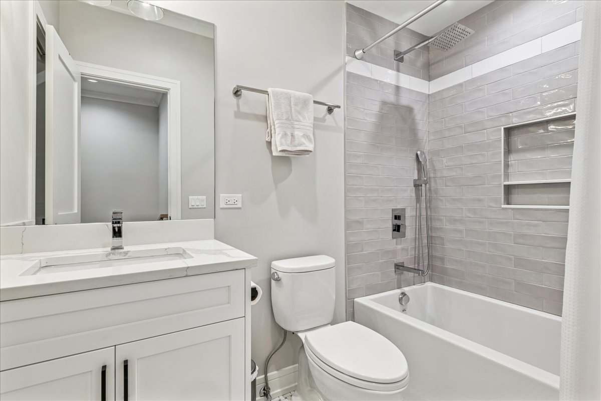1922 West Belmont Avenue, Unit 3 Chicago, IL 60657 - Photo 22 of 29 a bathroom with a sink toilet and shower