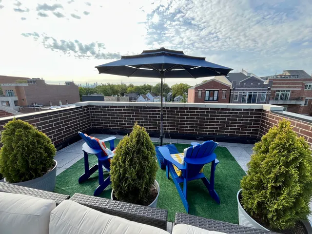 a view of a chairs and table in the back yard of the house