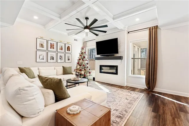 a living room with furniture a flat screen tv and a fireplace