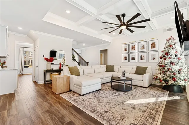 a living room with furniture and wooden floor