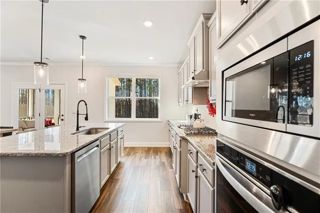 a kitchen with sink stove and cabinets