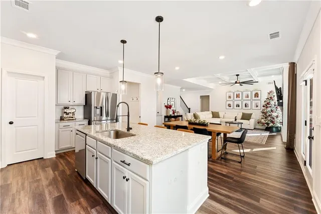 a kitchen with sink stove and refrigerator
