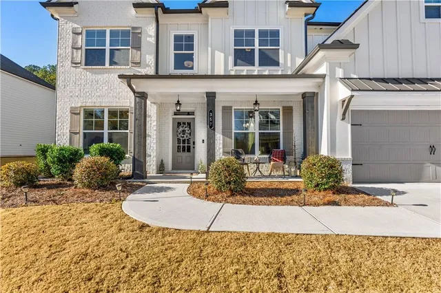 front view of a brick house with a small yard