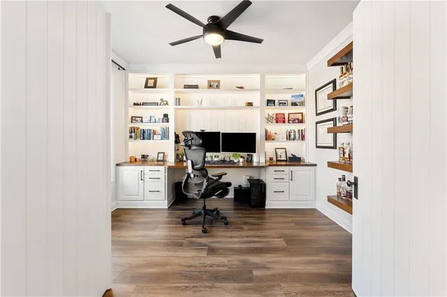 a view of a livingroom with workspace and a window