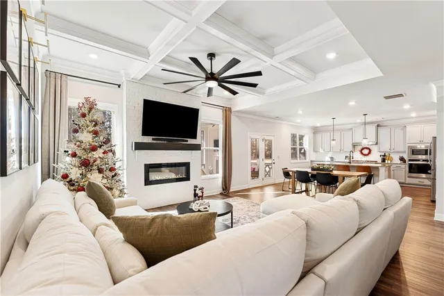 a living room with furniture a flat screen tv and a fireplace