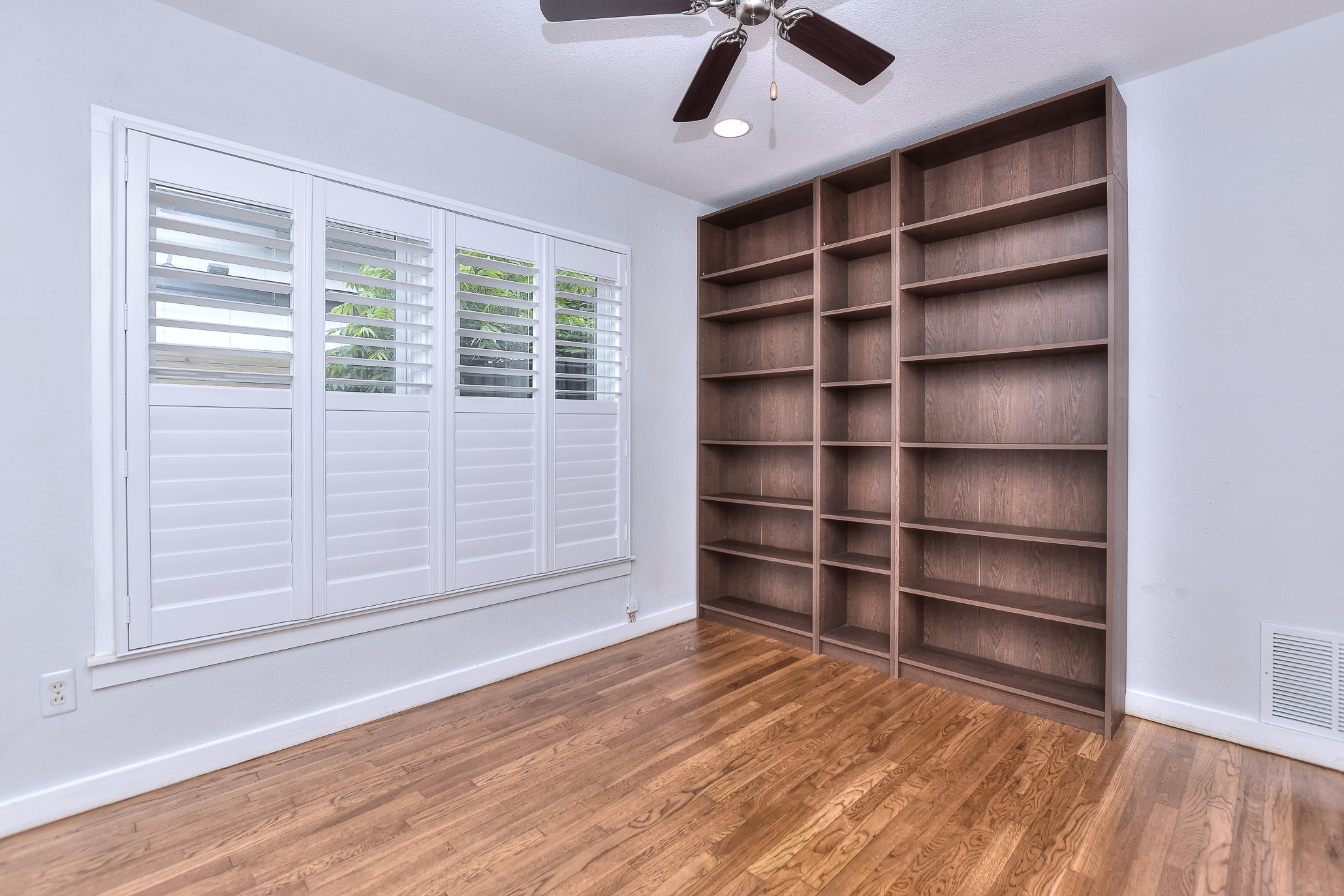 1309 Ridgemont Drive Austin, TX 78723 - Photo 21 of 35 Bedroom #2 offers a great space for use as a home office or exercise room....note the built-in bookcases!