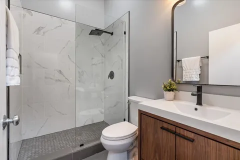 a bathroom with a sink toilet and shower