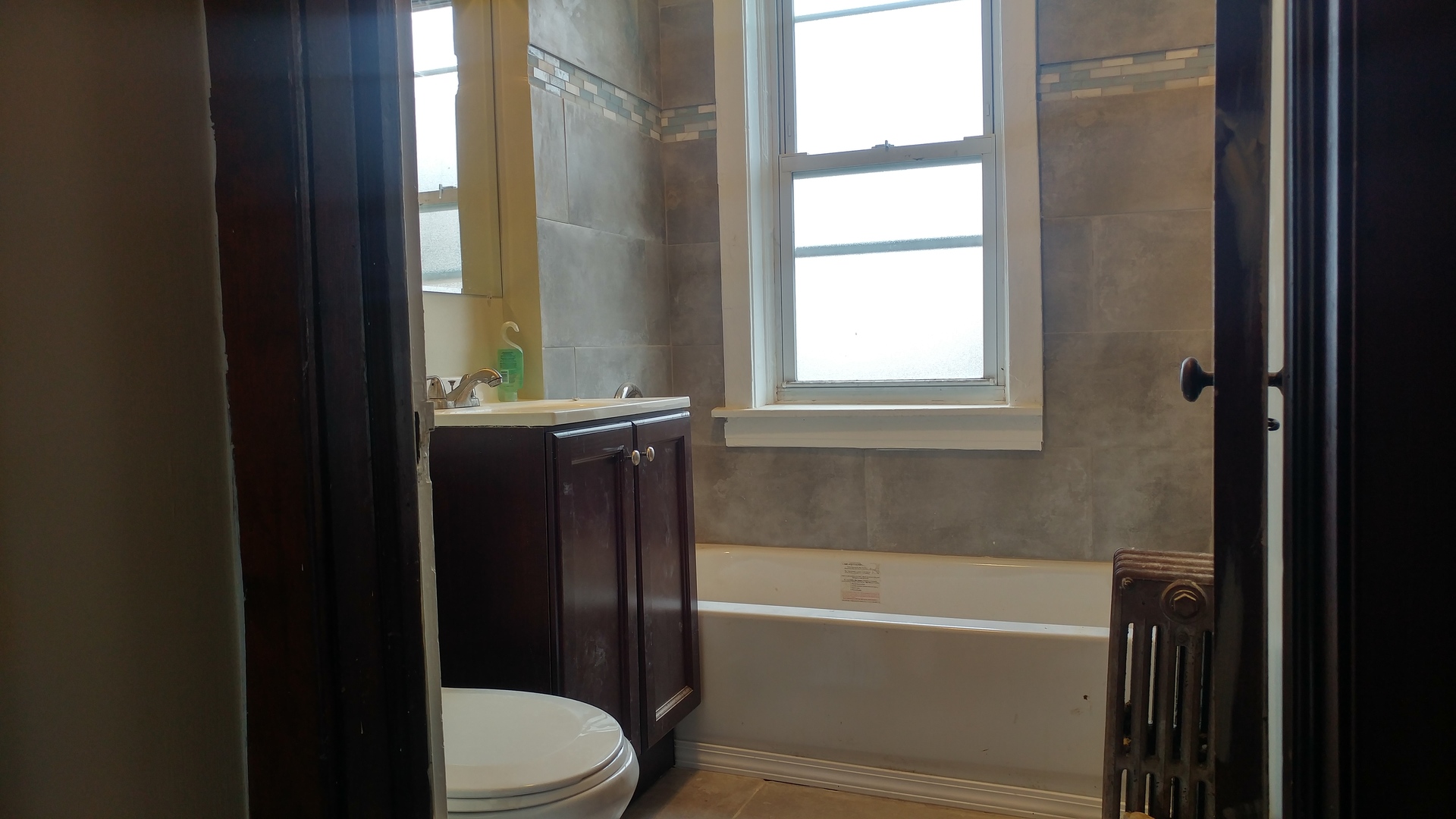 416 East 110th Street, Unit 3 Chicago, IL 60628 - Photo 5 of 7 a bathroom with a bathtub toilet and window