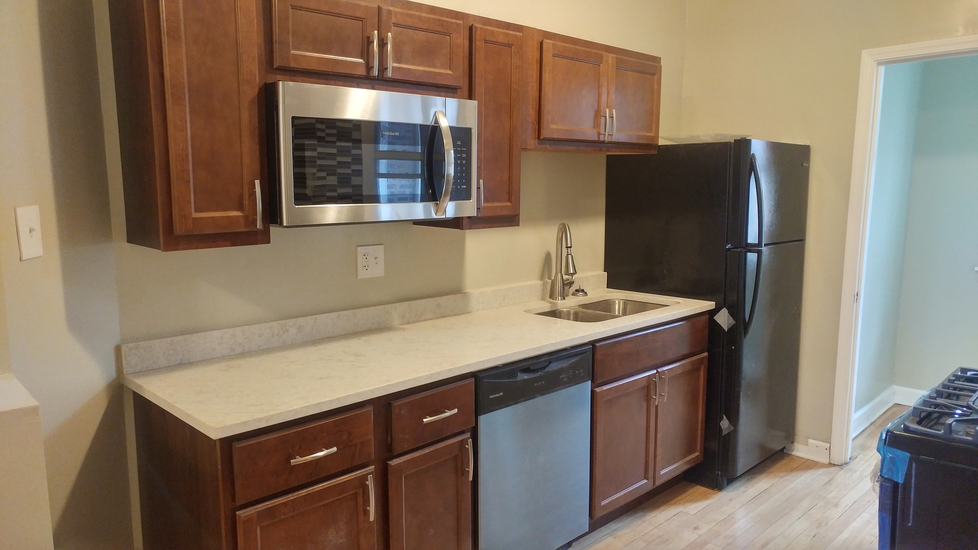 416 East 110th Street, Unit 3 Chicago, IL 60628 - Photo 7 of 7 a kitchen with a sink and a refrigerator