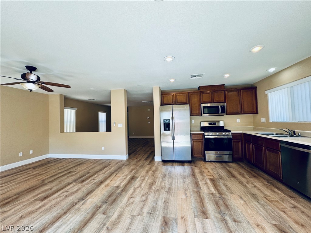 8617 Palomino Ranch Street Las Vegas, NV 89131 - Photo 11 of 27 A contemporary kitchen and living area offer a comfortable, well-appointed setting.