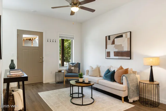 a living room with furniture and a lamp