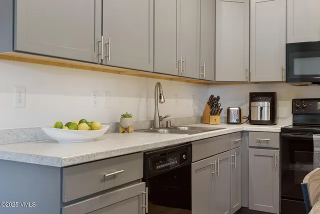 a kitchen with stainless steel appliances granite countertop a sink a stove and cabinets