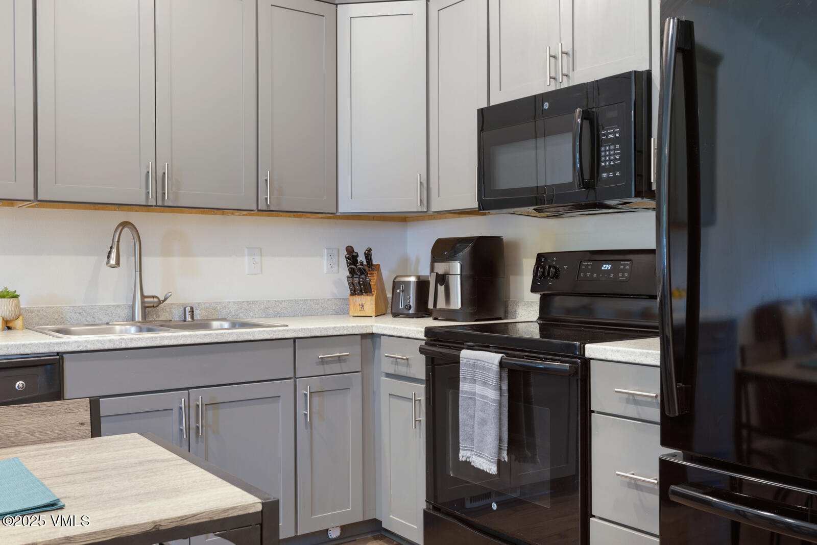 4 Uneva Court, Unit B1 Eagle, CO 81631 - Photo 12 of 44 a kitchen with stainless steel appliances granite countertop a sink stove and microwave