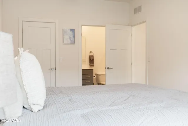 a view of a room with wooden floor and white walls