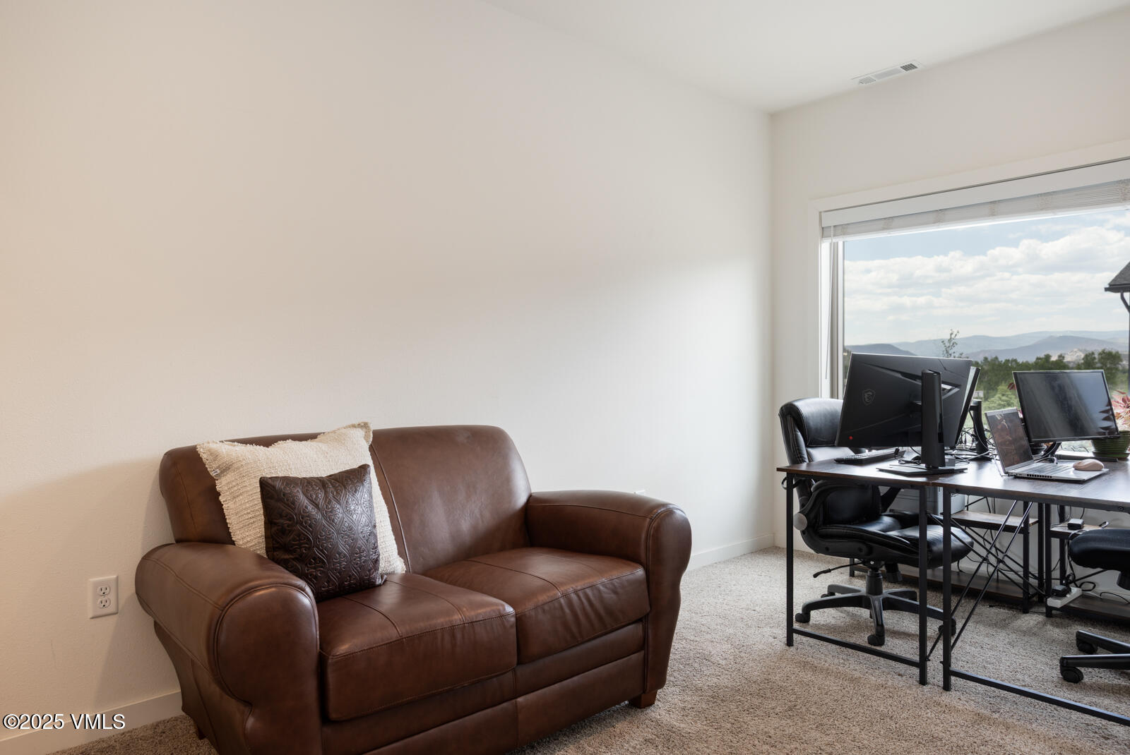 4 Uneva Court, Unit B1 Eagle, CO 81631 - Photo 21 of 44 a living room with furniture a flat screen tv and a large window