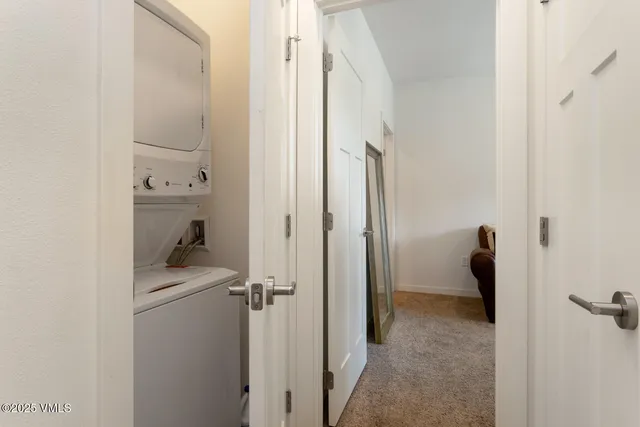 a view of a hallway with wooden floor and entryway