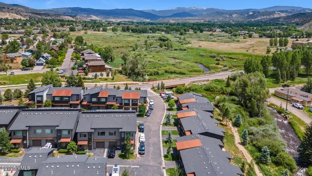 an aerial view of residential houses with outdoor space