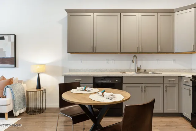 a kitchen with a sink a table and chairs