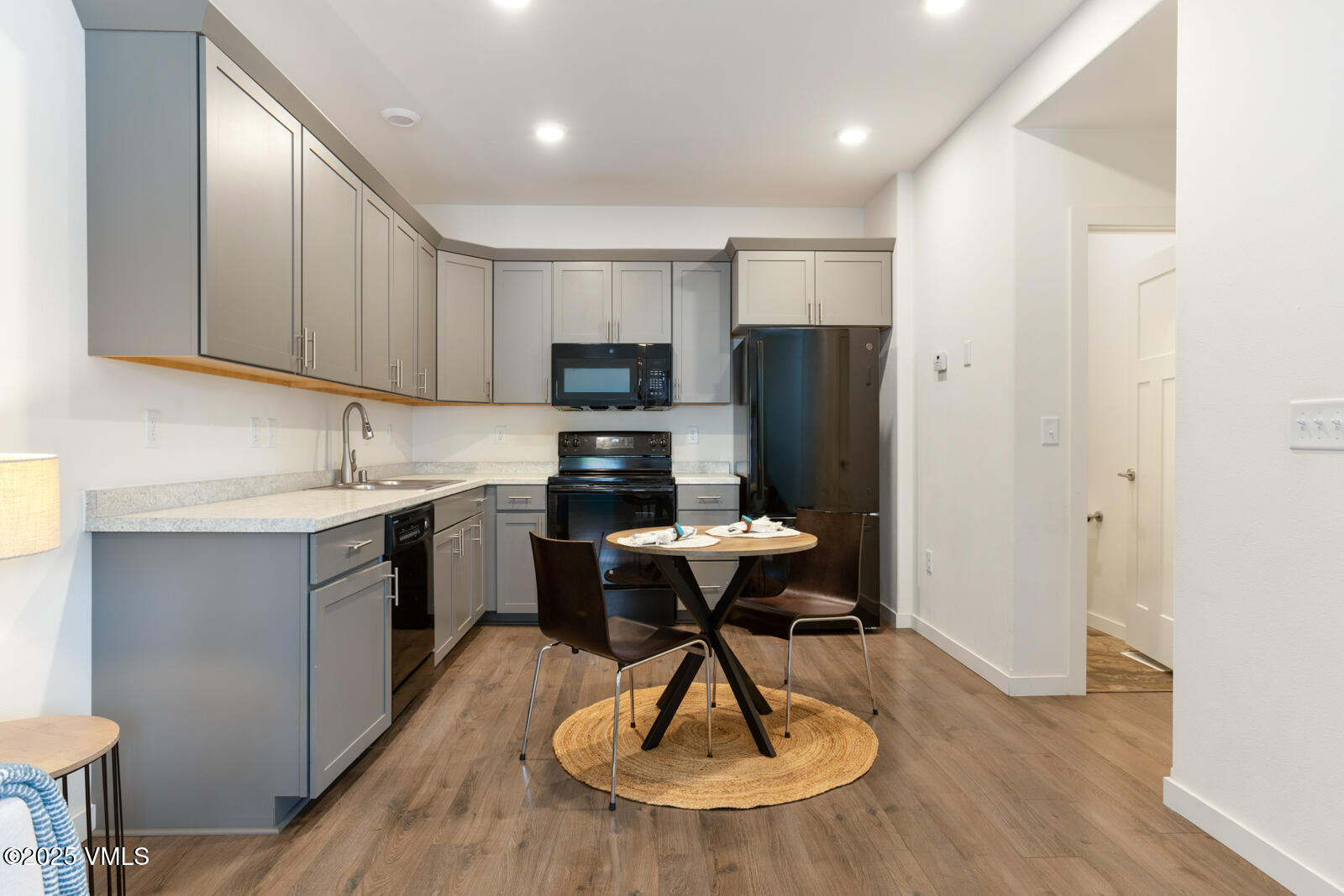 4 Uneva Court, Unit B1 Eagle, CO 81631 - Photo 10 of 44 a kitchen with stainless steel appliances granite countertop a sink dishwasher a refrigerator and a stove with wooden floor