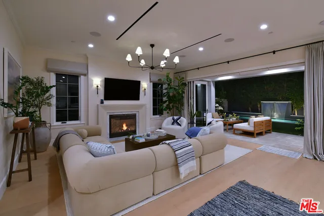 a bedroom with furniture and a large window