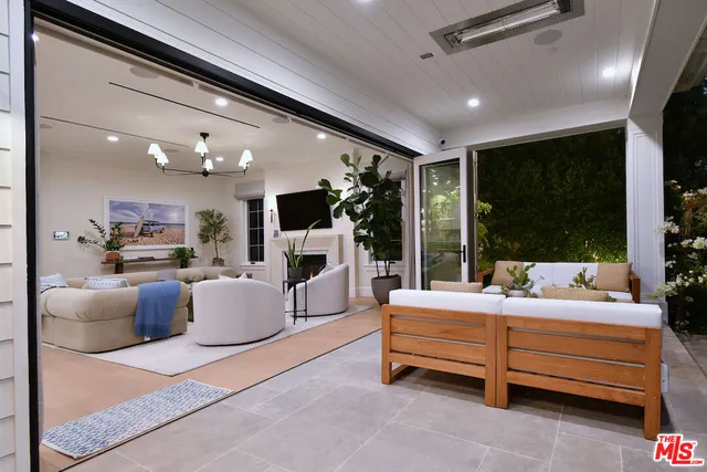 a backyard of a house with a garden and outdoor seating