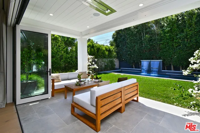 a outdoor space with patio couch and a garden