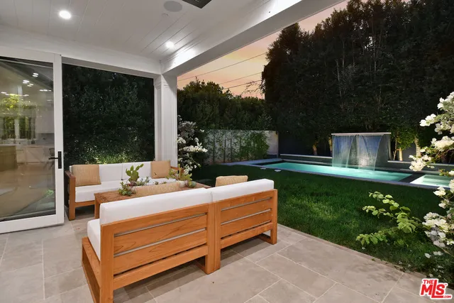 a view of a garden with lawn chairs