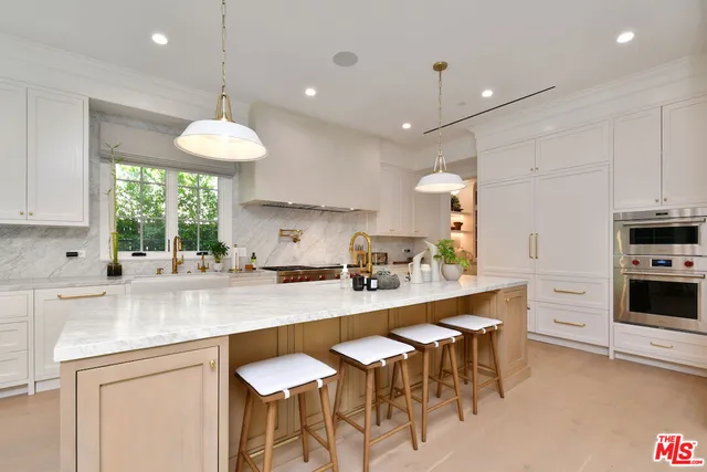 a bathroom with a double vanity sink and mirror with shower
