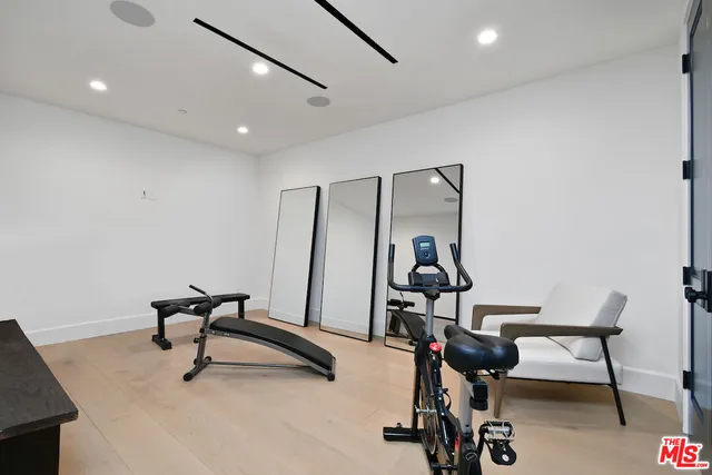 a workspace room with furniture and wooden floor